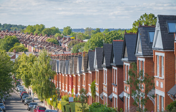 Row of English traditional terraced houses on hill in Crouch End, North London