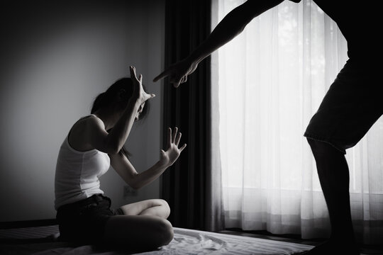 Woman and man in a tense conflict with a defensive gesture, representing relationship crisis, domestic conflict awareness, emotional distress, respect, communication, safety, prevention, equality.