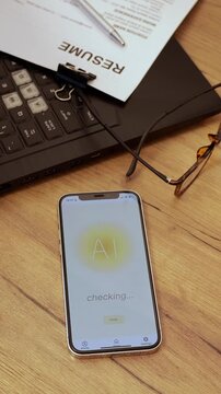 Mobile phone screen and resume form on it. Process of reviewing and grammar checking, improve CV to apply for job position