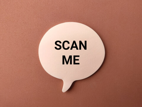 A beige speech bubble featuring the text "SCAN ME" placed on a brown textured surface