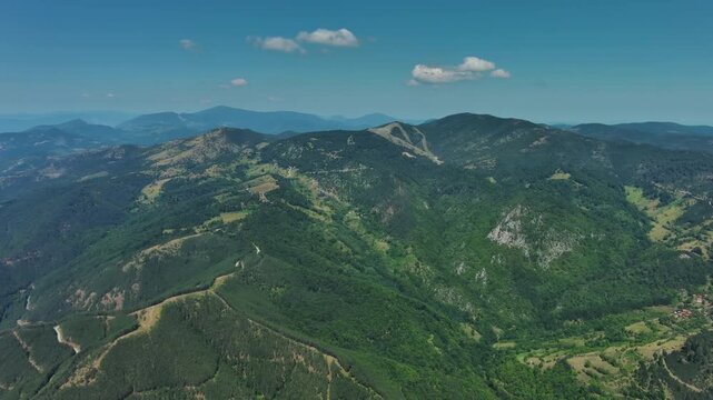 Aerial view of green hills and mountains and ethno village Mokra Gora, Serbia, panorama 4k