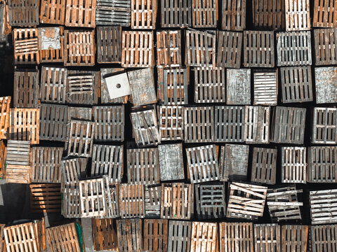 Aerial view of wooden pallets for packaging and transportation arranged in a grid pattern, Poland.