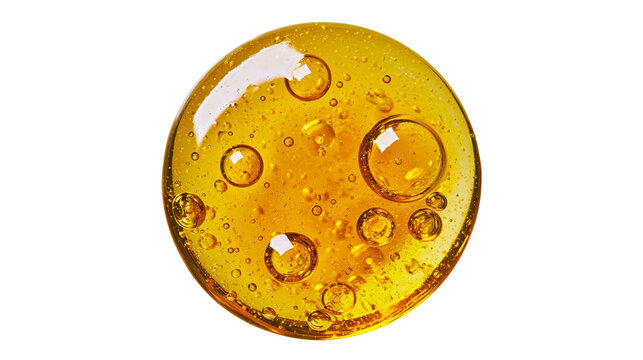 Viscous golden honey drop with air bubbles, isolated on transparent background