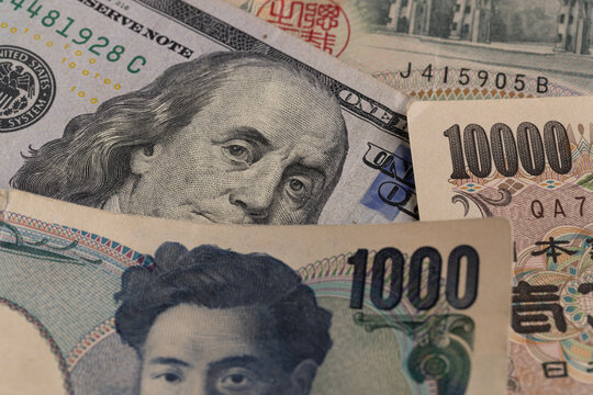Macro detail of Japanese 1000 and 10000 yen bills mixed with US 100 dollar banknote