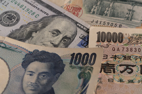Macro detail of Japanese 1000 and 10000 yen bills mixed with US 100 dollar banknote