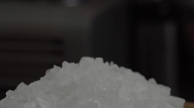 Macro close up of coarse sea salt crystals forming a textured pile, showcasing natural mineral structure and culinary ingredient used for seasoning and cooking