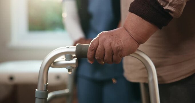 Senior, person and hands with nurse on walker for mobility, walking aid or rehabilitation in clinic. Elderly, caregiver or patient with balance for movement, recovery or physiotherapy in hospital