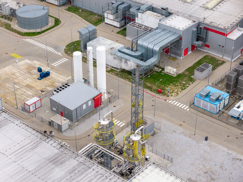 Aerial view of an advanced food production facility featuring large white liquid gas tanks, complex ventilation systems, and industrial piping in Poland.