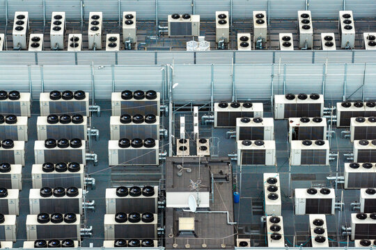 Aerial view of an AI data center rooftop featuring rows of industrial cooling units and HVAC systems in Warsaw, Masovian Voivodeship, Poland.