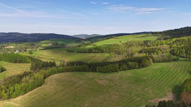 Rolling hills static, in rural landscape with green fields and trees under, with fields, trees, hills, from a aerial view perspective, with green, blue accents, and serene and peaceful mood.