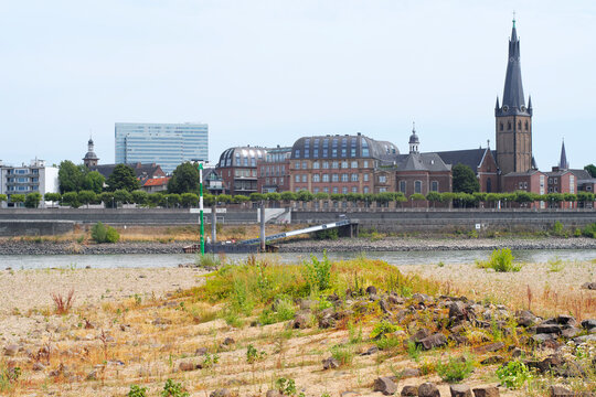 Low stream gauge of rhine river in D&uuml;sseldorf,Germany.Water shortage, drought, climate change,global warming concept, due to the drought, plants are conquering the former riverbed
