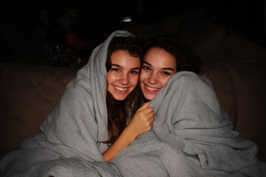 Teens Bonding With Blanket and Snacks During Scary Movie