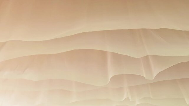thin beige fabric waving in the wind creating abstract flowing background. soft fabric ripples form elegant curves for design intro. concept of abstract fabric texture for creative backdrop