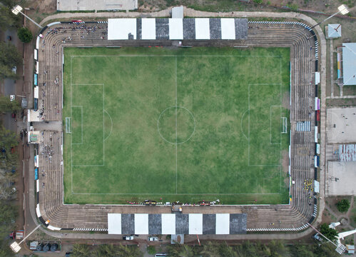 Aerial view of a soccer stadium with a green pitch and surrounding seating areas in Jinotepe, Carazo, Nicaragua.