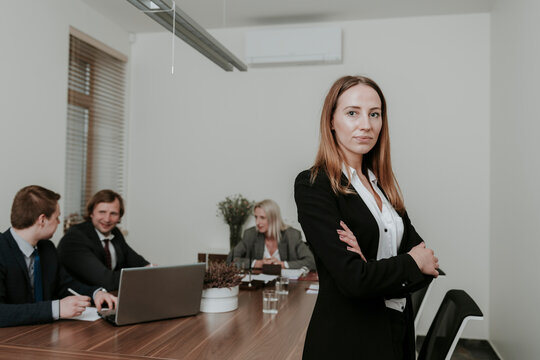 Portrait of confident young businesswoman on a meeting in conference room