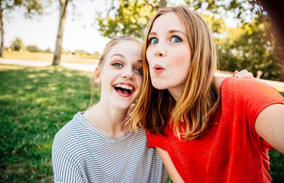 Two playful teenage girls taking a selfie