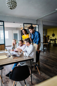 Confident business team having a meeting in loft office
