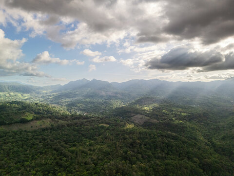 Aerial view of the lush mountainous landscape with dense tropical forests, rolling hills, and dramatic cloud formations in La Dalia, Matagalpa, Nicaragua.