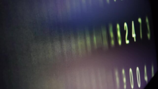 Digital data sequence displaying glowing green numeric codes on dark background