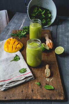 Glasses of spinach smoothie with mango, lime juice and hemp seed