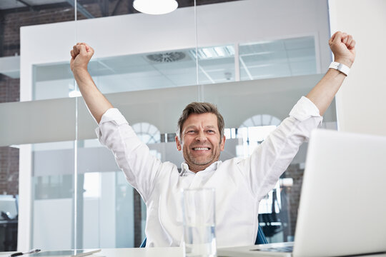 Enthusiastic businessman in office