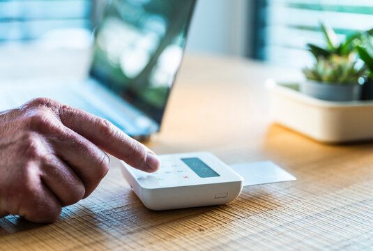 Man uses a card reader for payment at the office desk