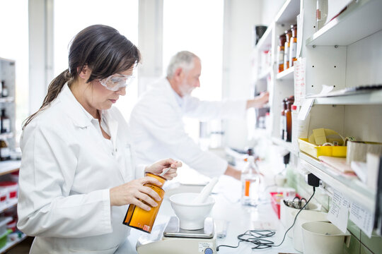 Man and woman working in laboratory of a pharmacy