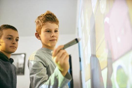 Students in class at interactive whiteboard