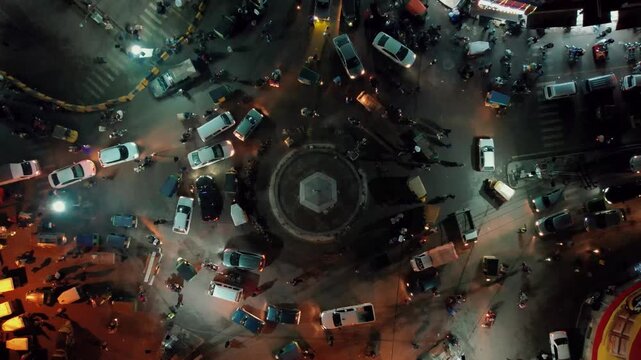 Drone View Over Fawara Chowk Rawalpindi Showing a Busy Urban Intersection Illuminated by Street Lights at Night