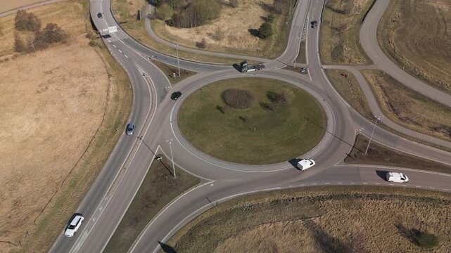 Aerial view of rural roundabout with moving vehicles