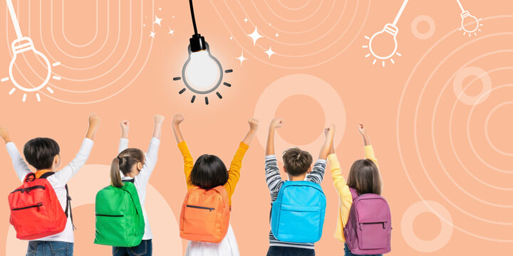 Creativity and education with a group of students raising their hands towards a bright light bulb