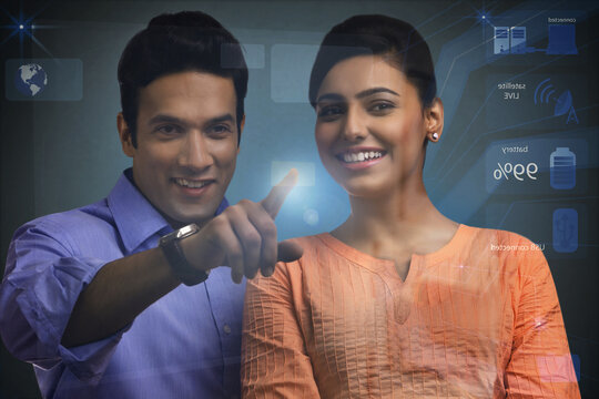 Digital composite of two business colleagues using futuristic touch screen