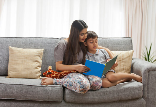 Mother and son looking at photograph album