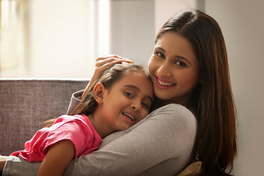 Portrait of a woman hugging her daughter