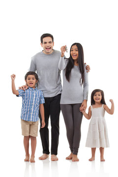 Family holding keys to new house