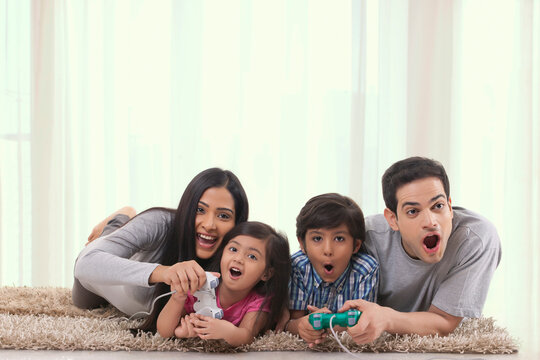 Cheerful family playing video game at home