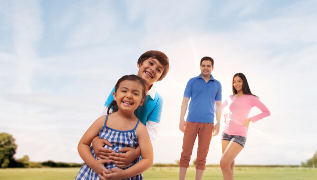 Parents watching their children playing in the park on sunny day
