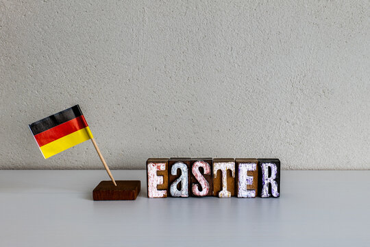 EASTER in Germany with National Flag and Rustic Wooden Letter Blocks