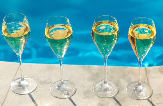 Champagne by the pool. Selective focus.