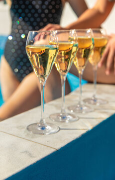 Champagne by the pool. Selective focus.