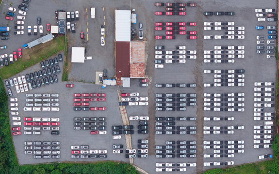 Aerial view of a large vehicle storage lot filled with rows of parked cars and trucks in Managua, Managua, Nicaragua.