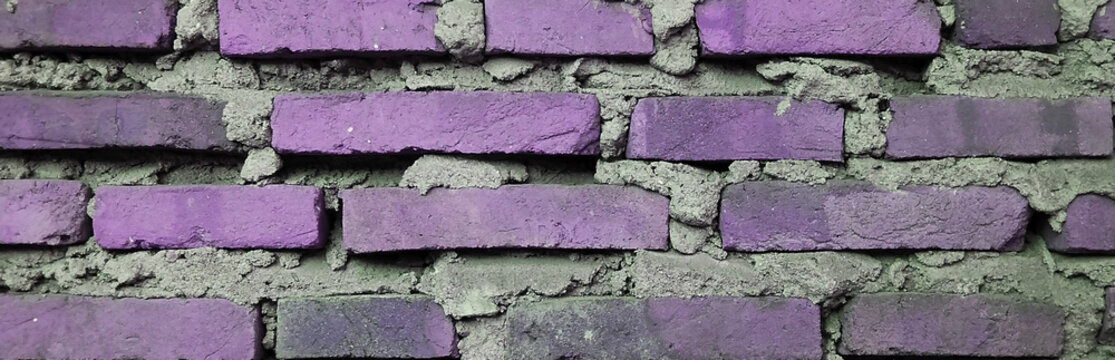 Purple painted brick wall texture on cement background