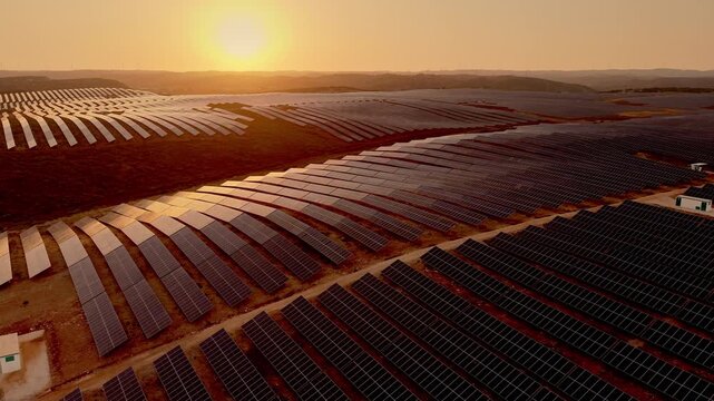  Aerial view of large solar farm at sunset