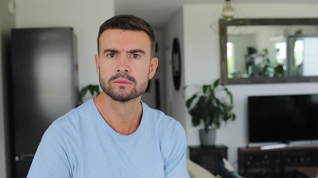 Angry man snapping fingers at camera to signal immediate stop