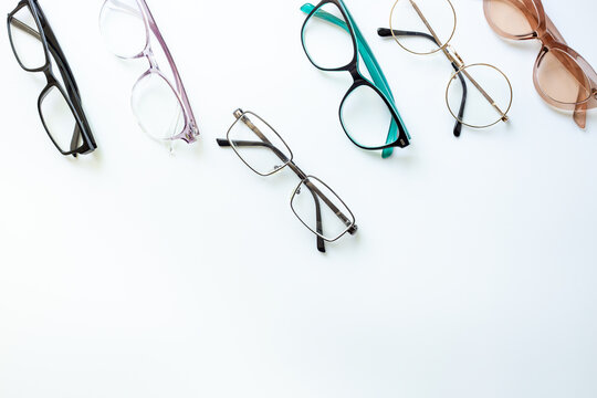 Set of glasses with different frame in optics store. Eyesight and vision concept.