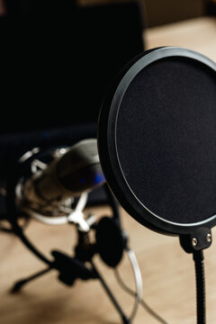 On the air concept - microphone with filter and laptop computer. Podcast recording