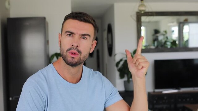 Doubting man counting five fingers toward camera before nodding with slight smile