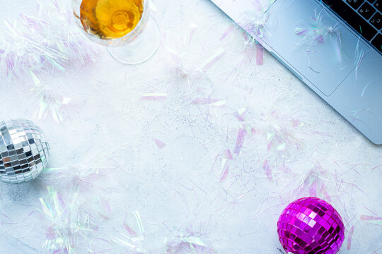 Work with fun. Laptop with confetti and disco balls, top view. Admin night party concept