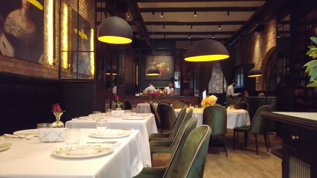 Elegant interior of upscale restaurant with floral decorations and professional table setting.
