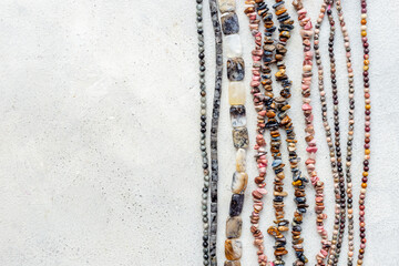 Obraz na płótnie Canvas Precious and jewelry flat lay background. Lots of gemstones for necklace and bracelets, top view